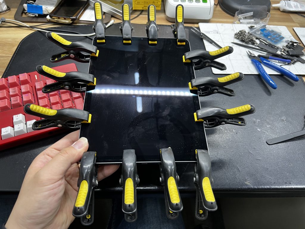 The iPad screen clamped to the body to ensure it adheres well.