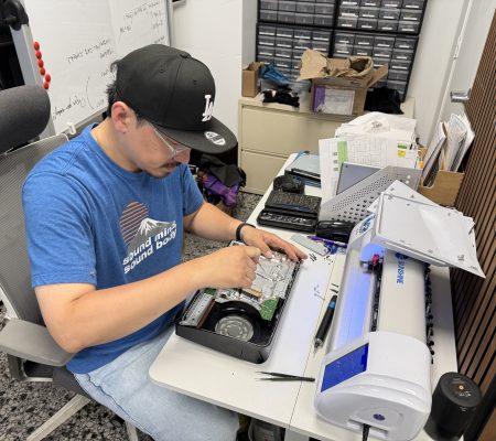 Skilled technician repairing a Samsung phone or tablet at a workbench
