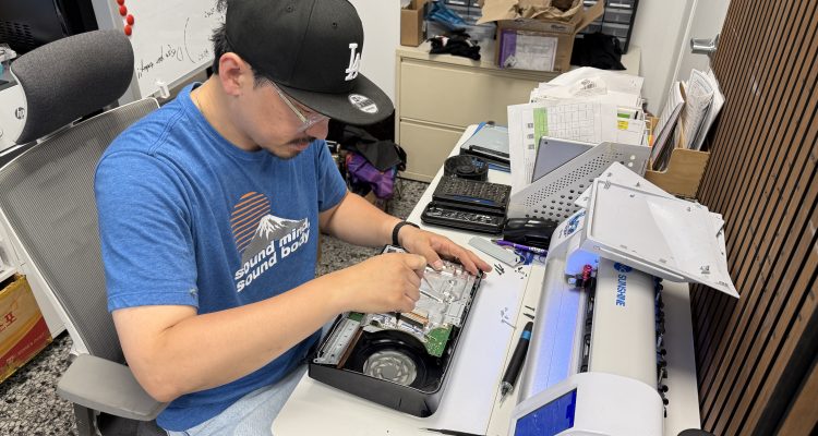 Skilled technician repairing a Samsung phone or tablet at a workbench